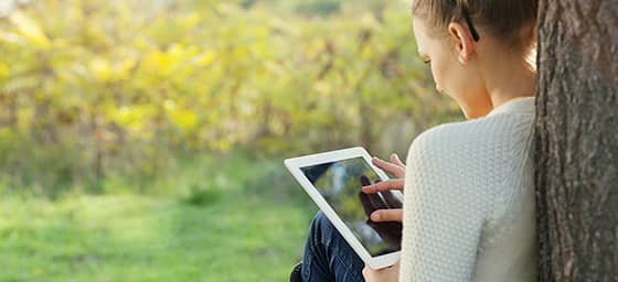 Woman sitting with an iPad